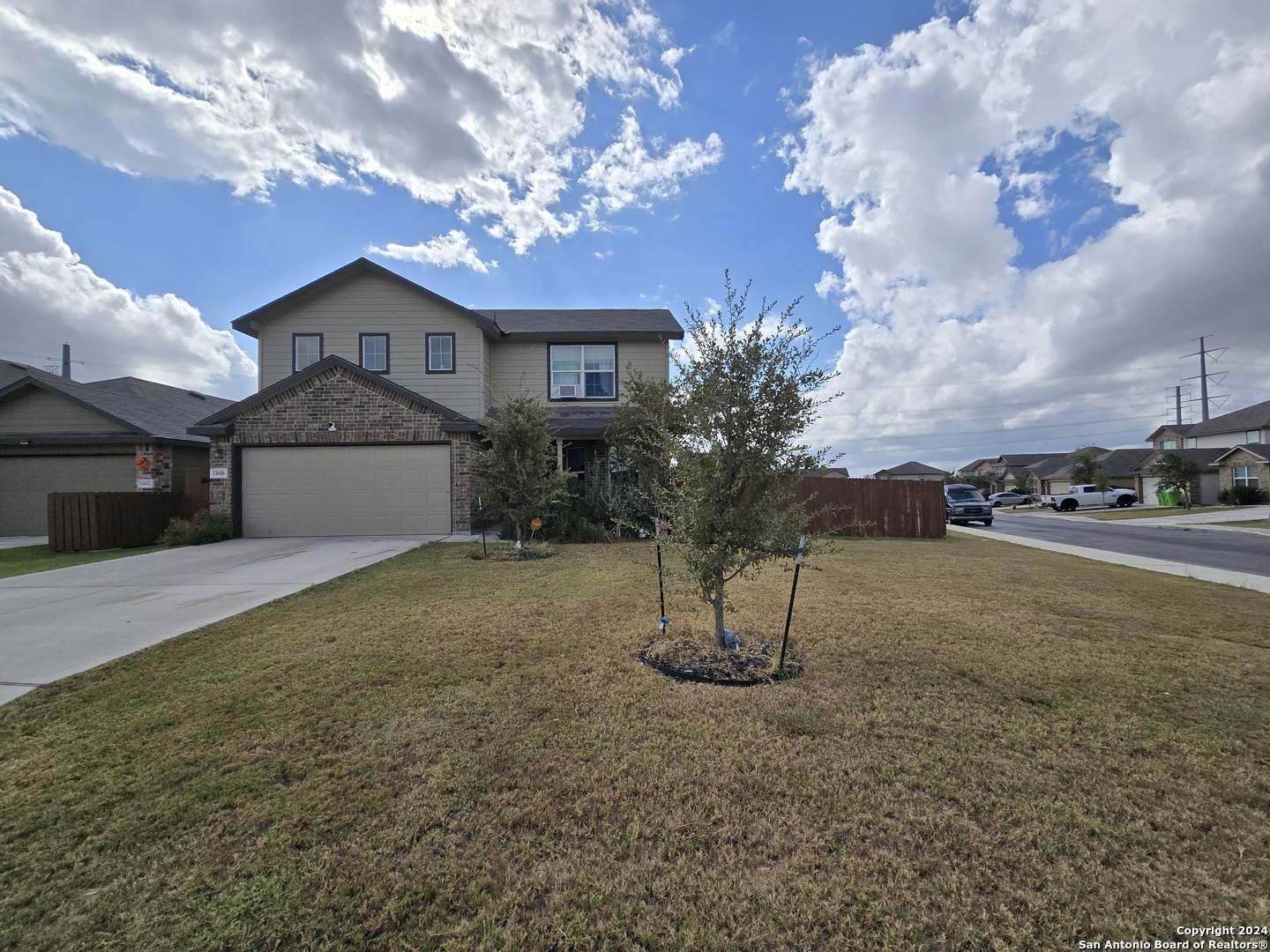 a view of a house with a yard and garage