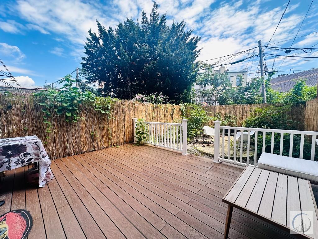 a view of backyard with a deck and wooden floor