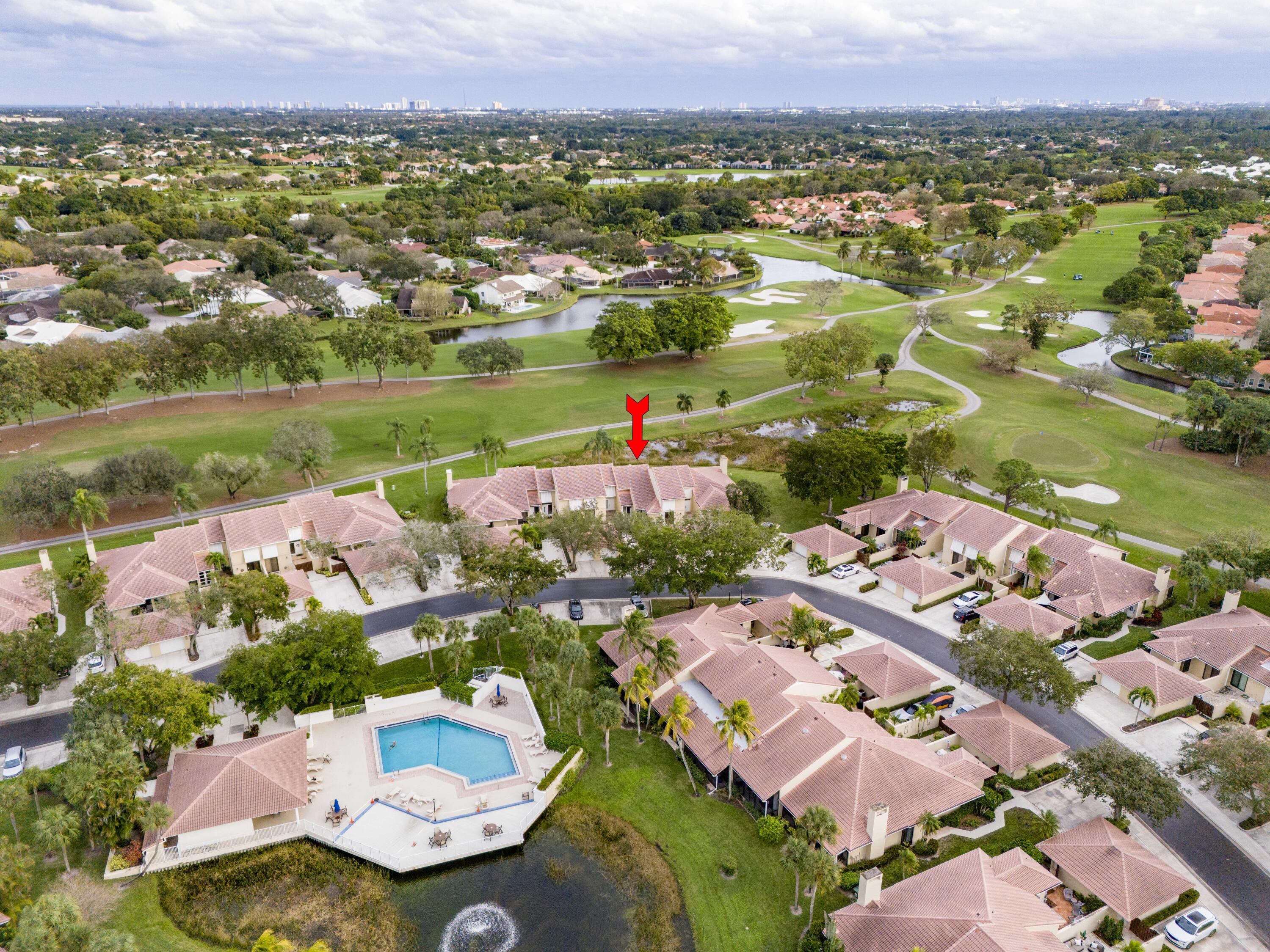 an aerial view of a houses with a lake