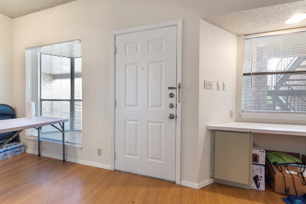 a view of livingroom with furniture hardwood floor and windows