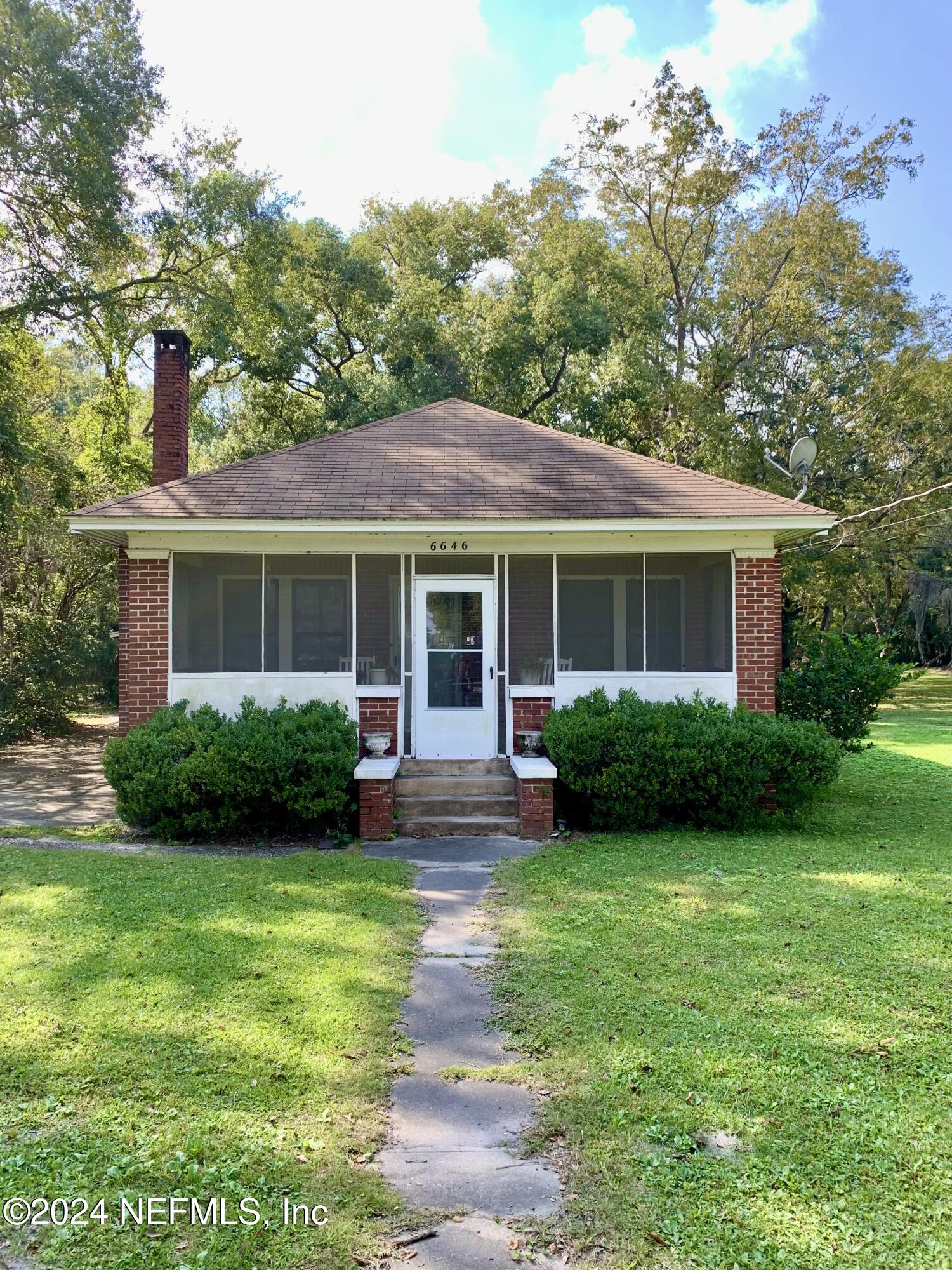 a front view of house with yard and green space