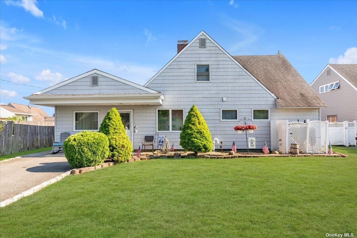 a front view of a house with a yard and porch