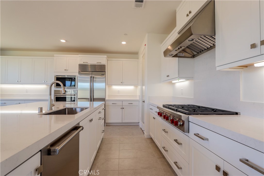 a kitchen with stainless steel appliances granite countertop a stove and a refrigerator