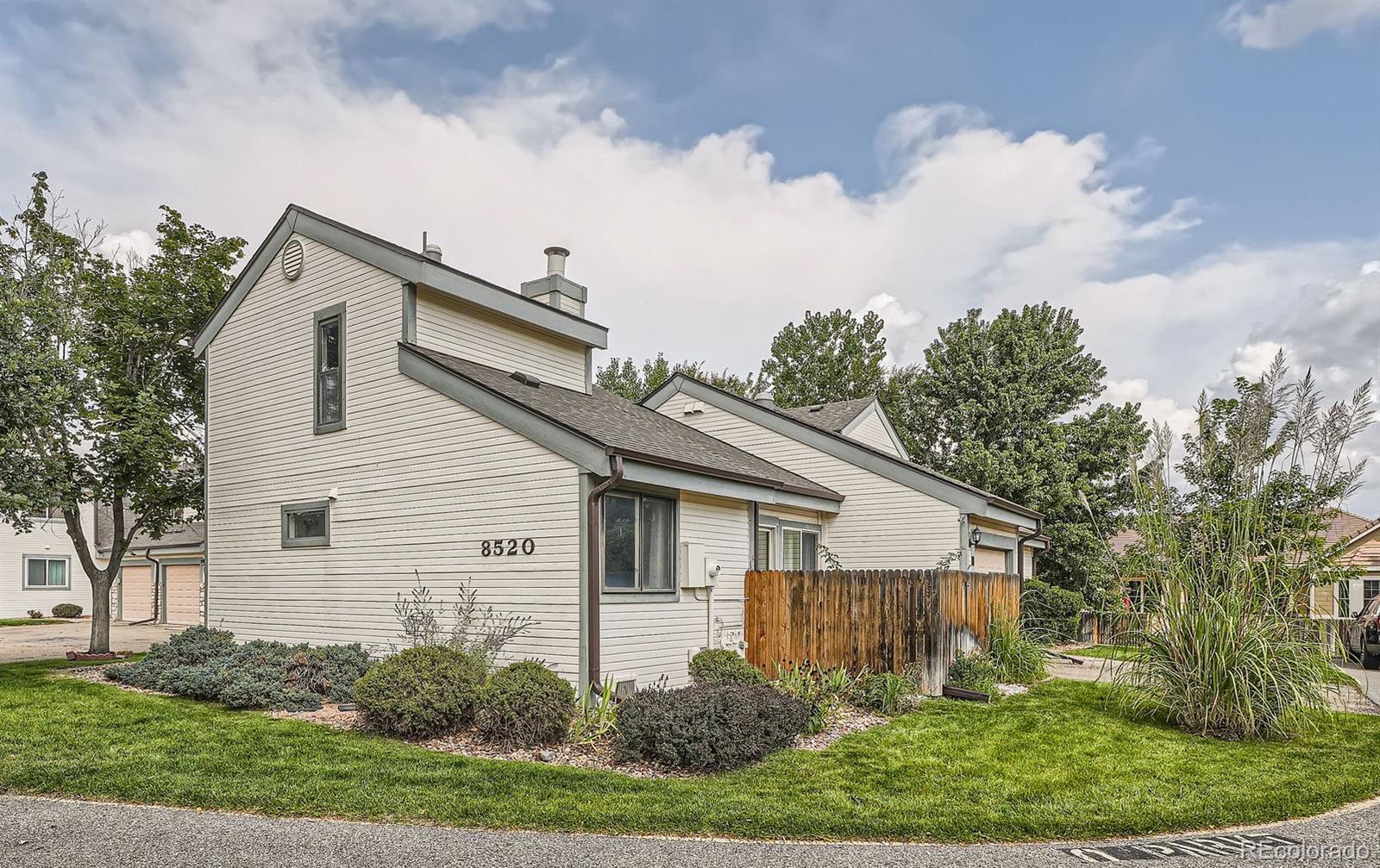 a view of a house with a yard