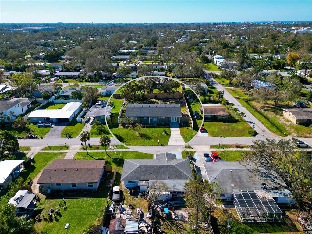 a view of multiple houses with outdoor space and parking