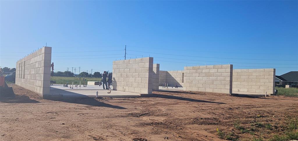 a view of a dry area with wooden fence