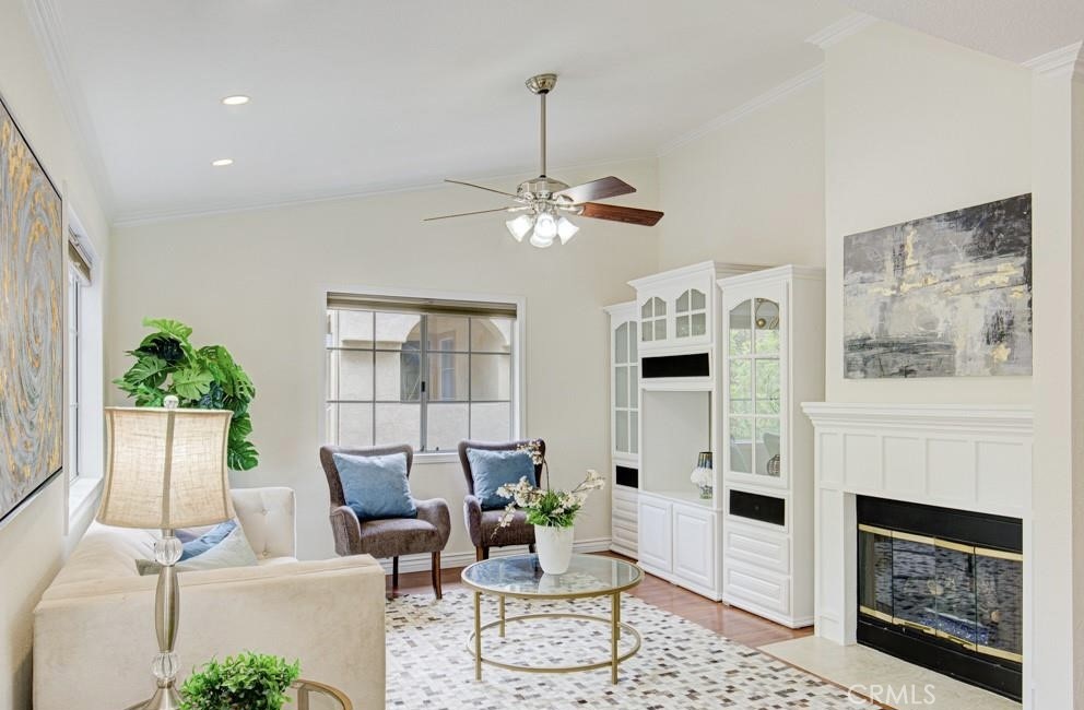 a living room with furniture a fireplace and a chandelier