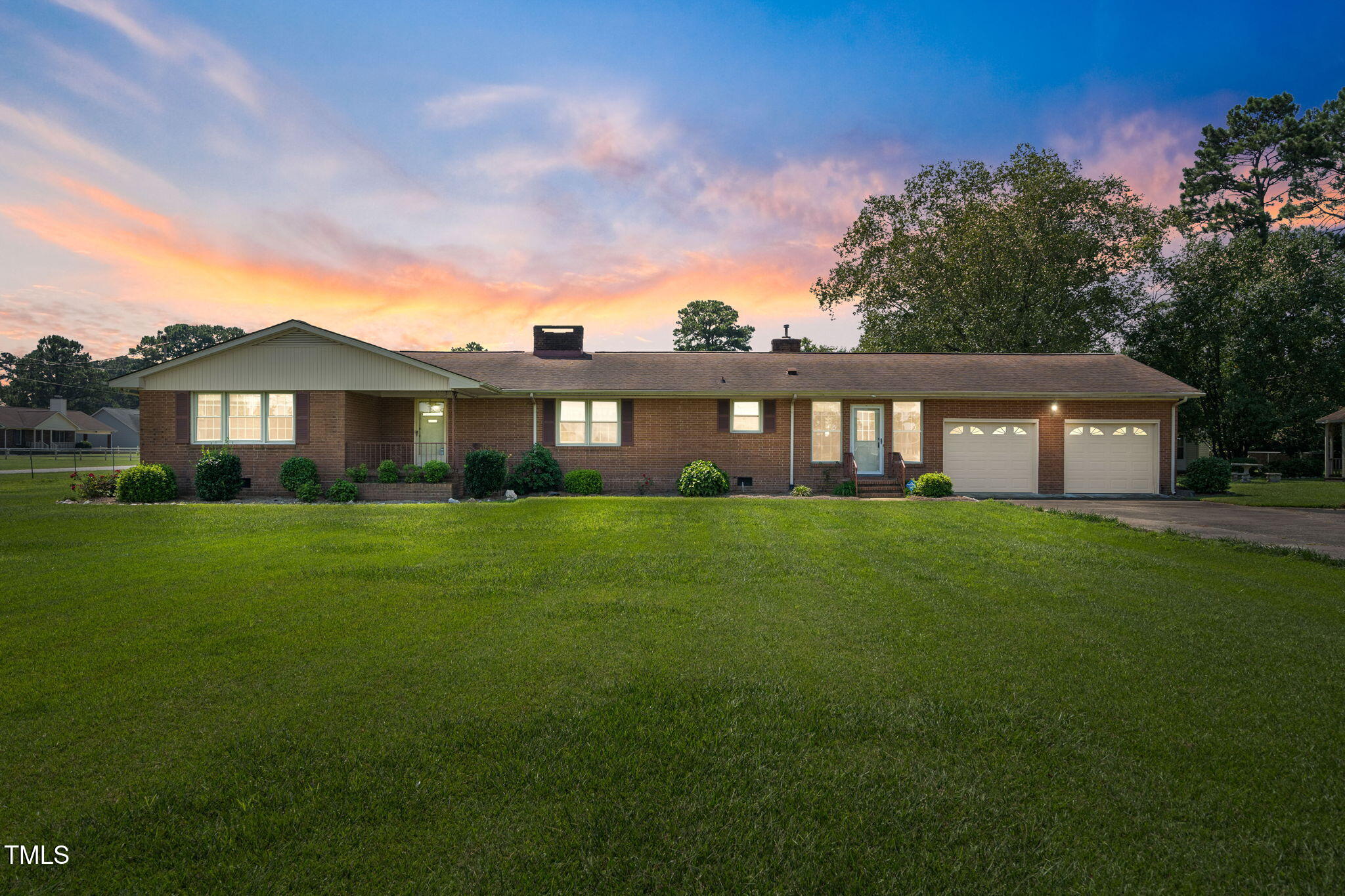 a front view of a house with a garden