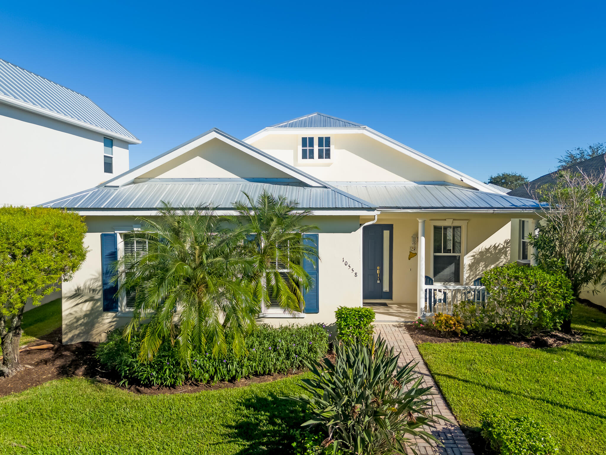 a front view of a house with a garden