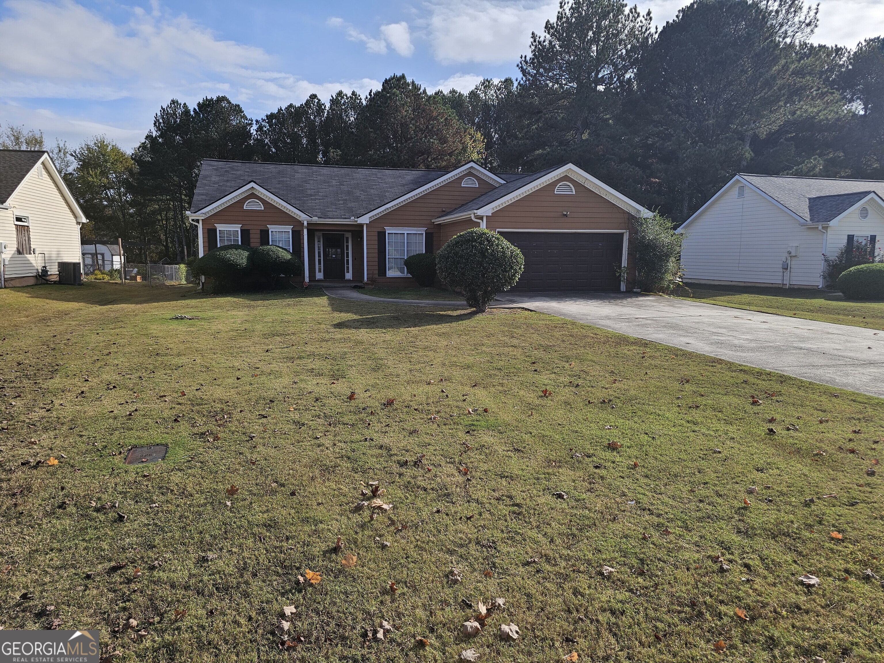 a front view of house with deck and yard