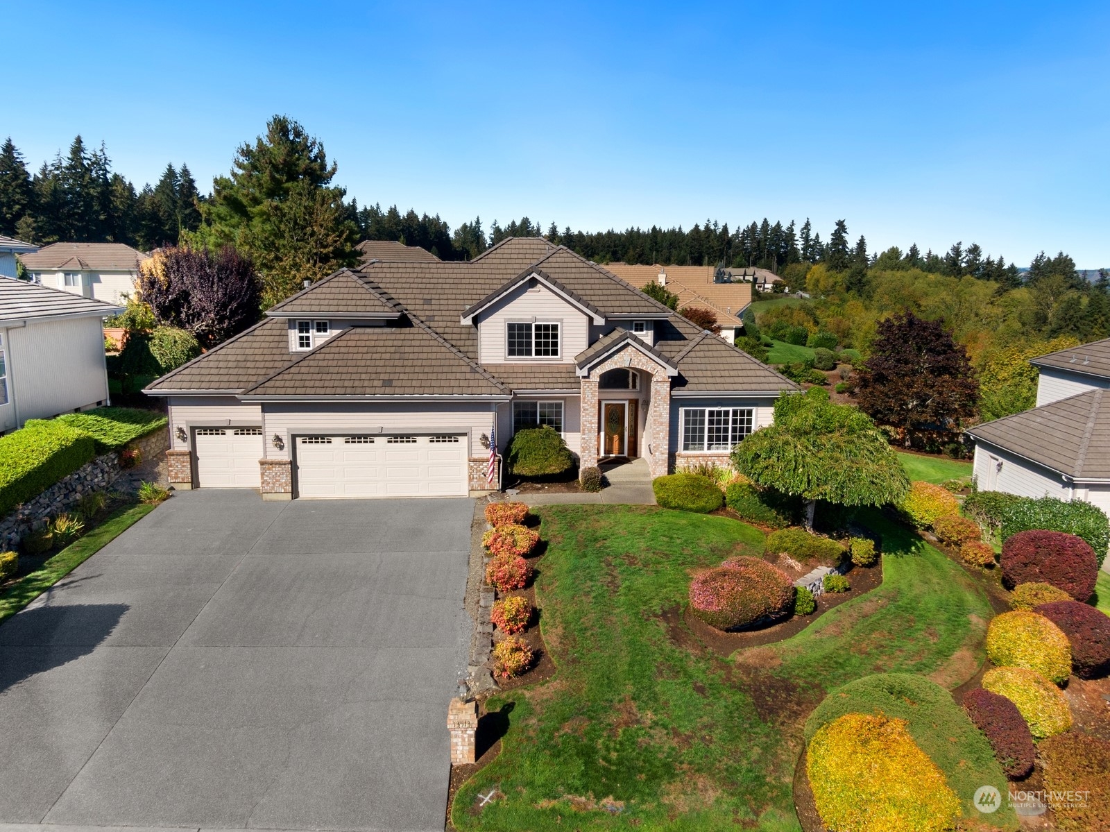 an aerial view of a house with swimming pool and a yard