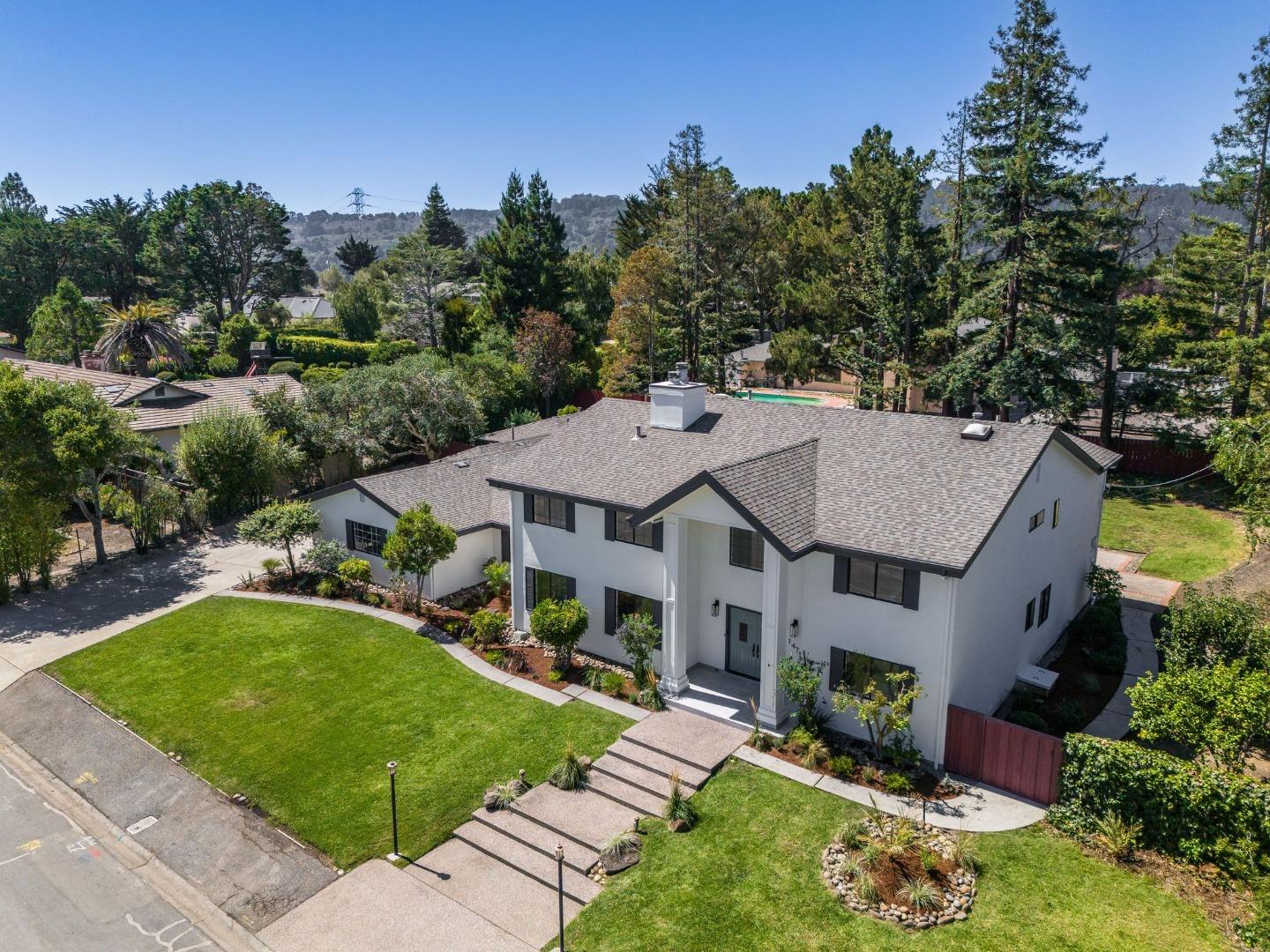 an aerial view of a house with swimming pool garden and patio