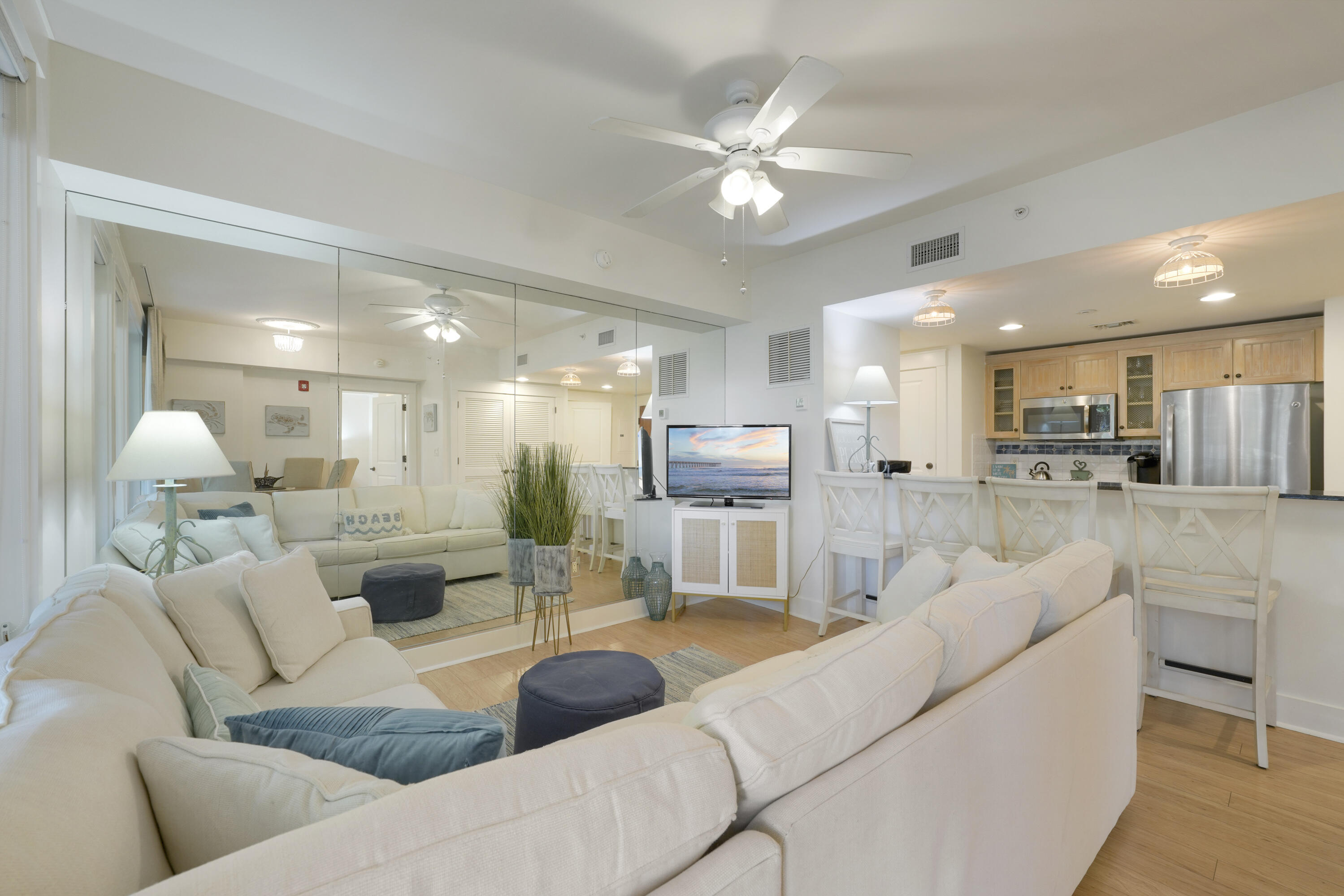 a living room with furniture and a view of kitchen