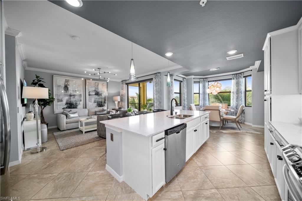 a large white kitchen with a large window and counter top