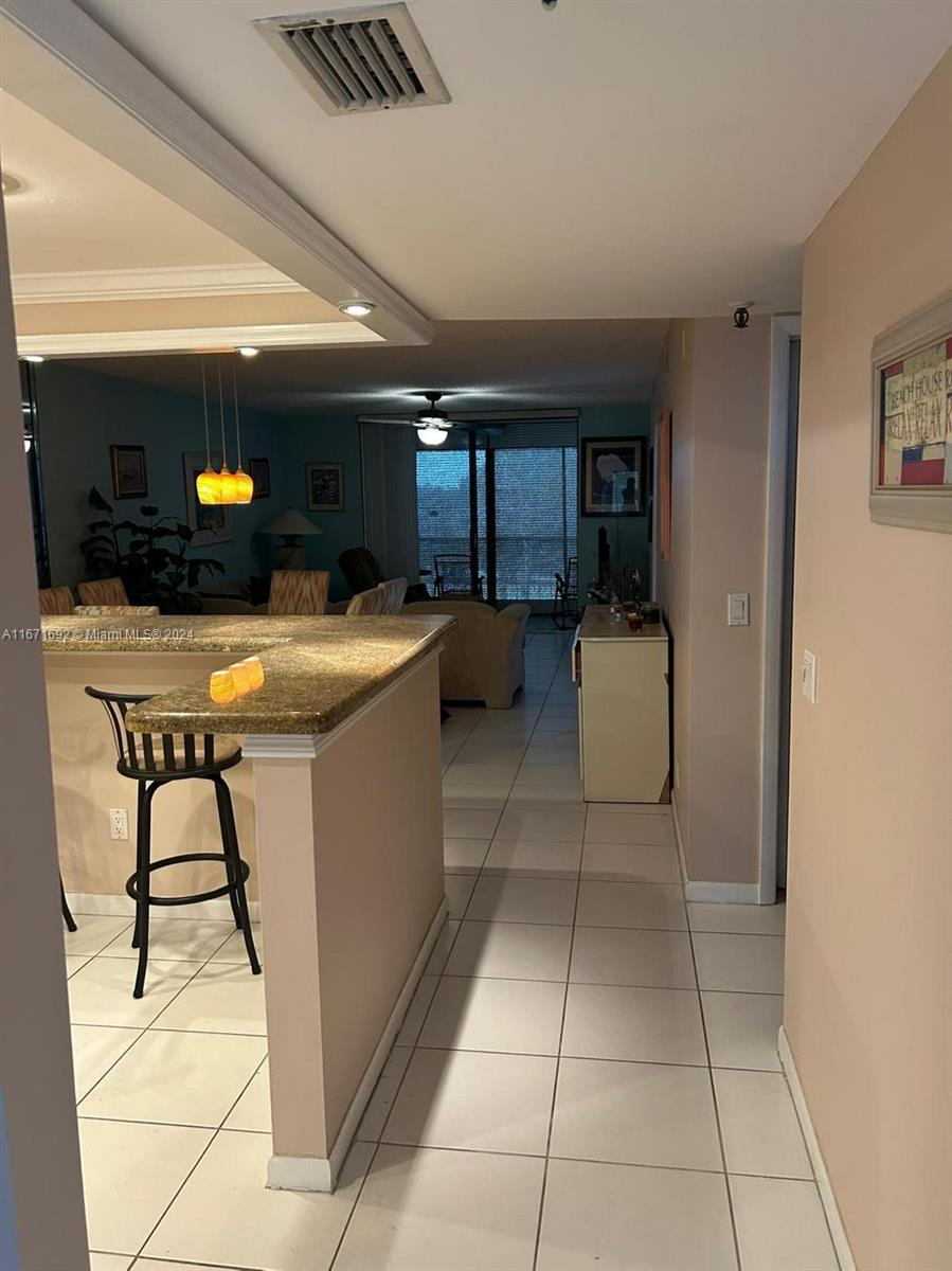 a kitchen with a sink a counter and chairs