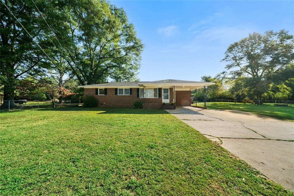 a front view of house with yard and green space