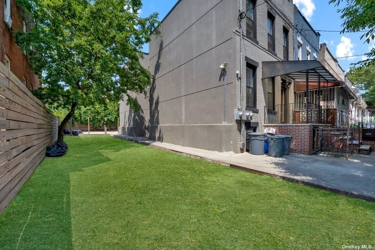 a view of a house with a yard and sitting area