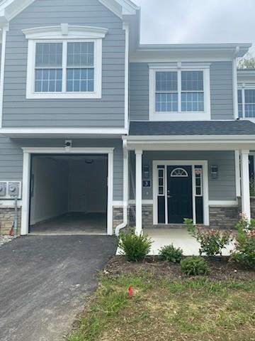 View of front facade featuring a garage