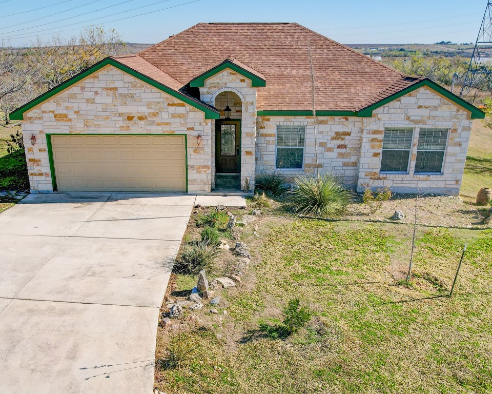 a front view of a house with garden