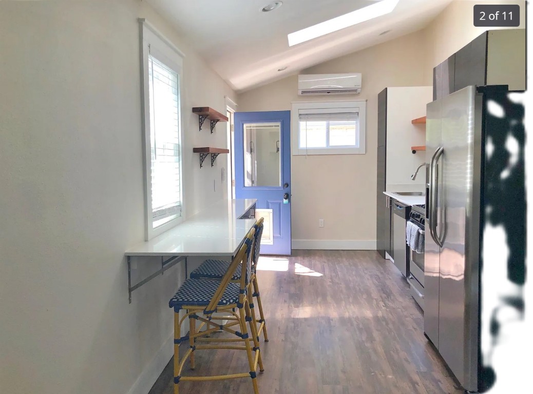 a view of a dining room with furniture and a window