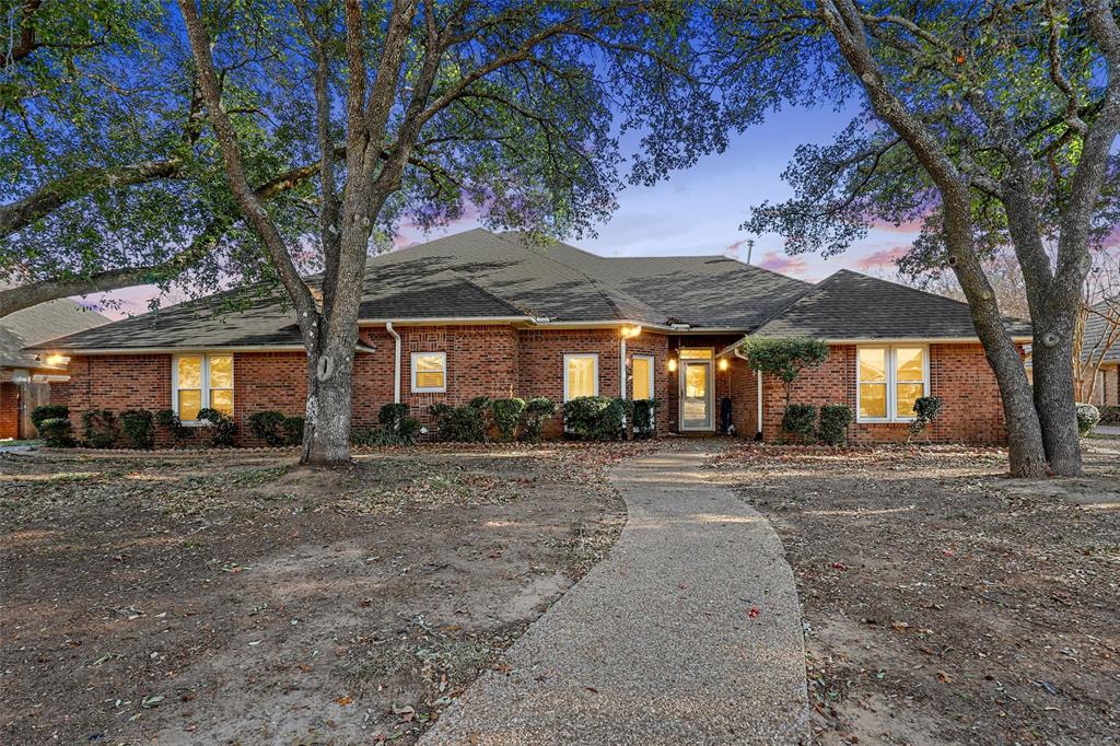 a view of a house with a tree in front of it