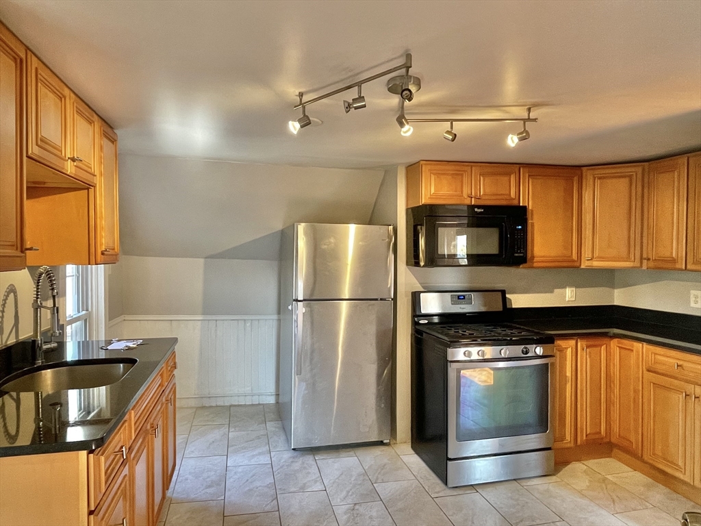 a kitchen with a sink appliances and cabinets