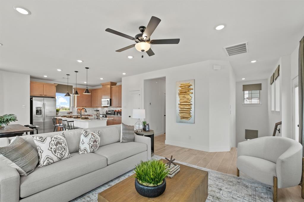 a living room with furniture kitchen and a chandelier