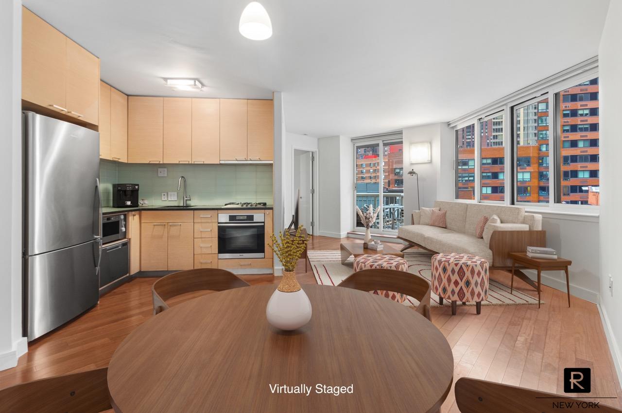 a kitchen with stainless steel appliances granite countertop a stove a refrigerator a sink dishwasher a dining table and chairs with wooden floor