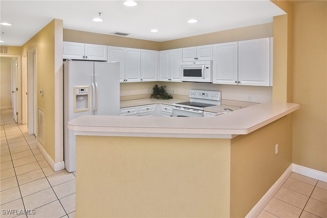 a kitchen with stainless steel appliances a refrigerator sink and cabinets