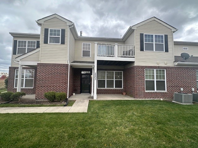 a front view of a house with a yard and porch