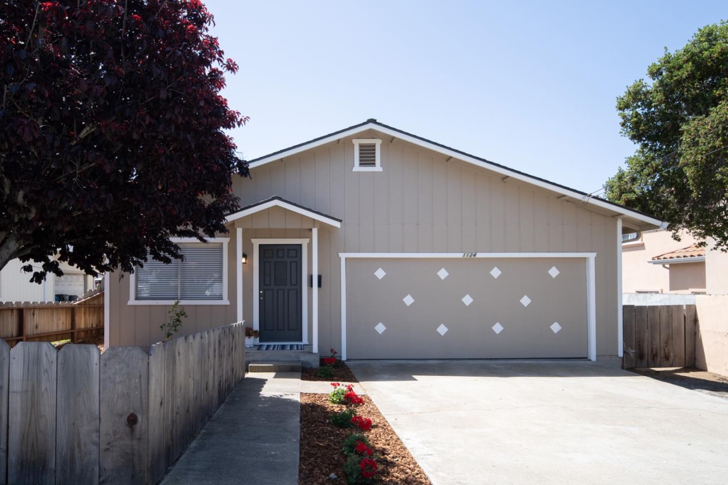 a front view of a house with trees