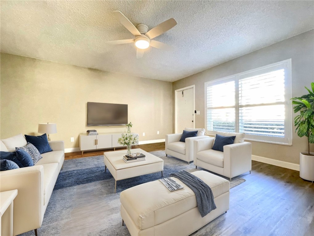 a living room with couches and a flat screen tv