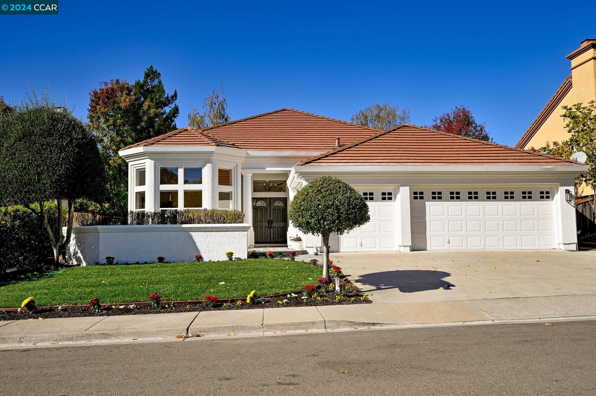 a front view of a house with a yard and garage