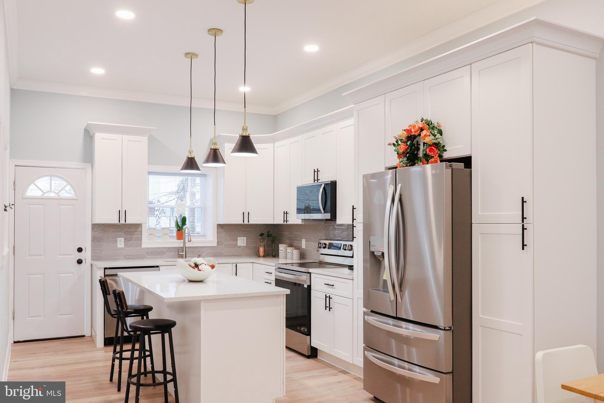 a kitchen with a sink a refrigerator and a stove