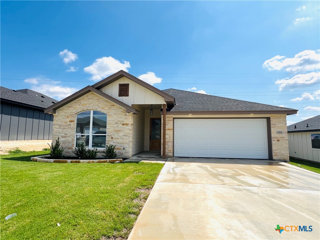 a front view of a house with a yard and garage