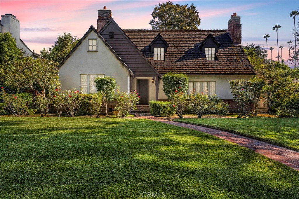 a front view of house with yard and green space