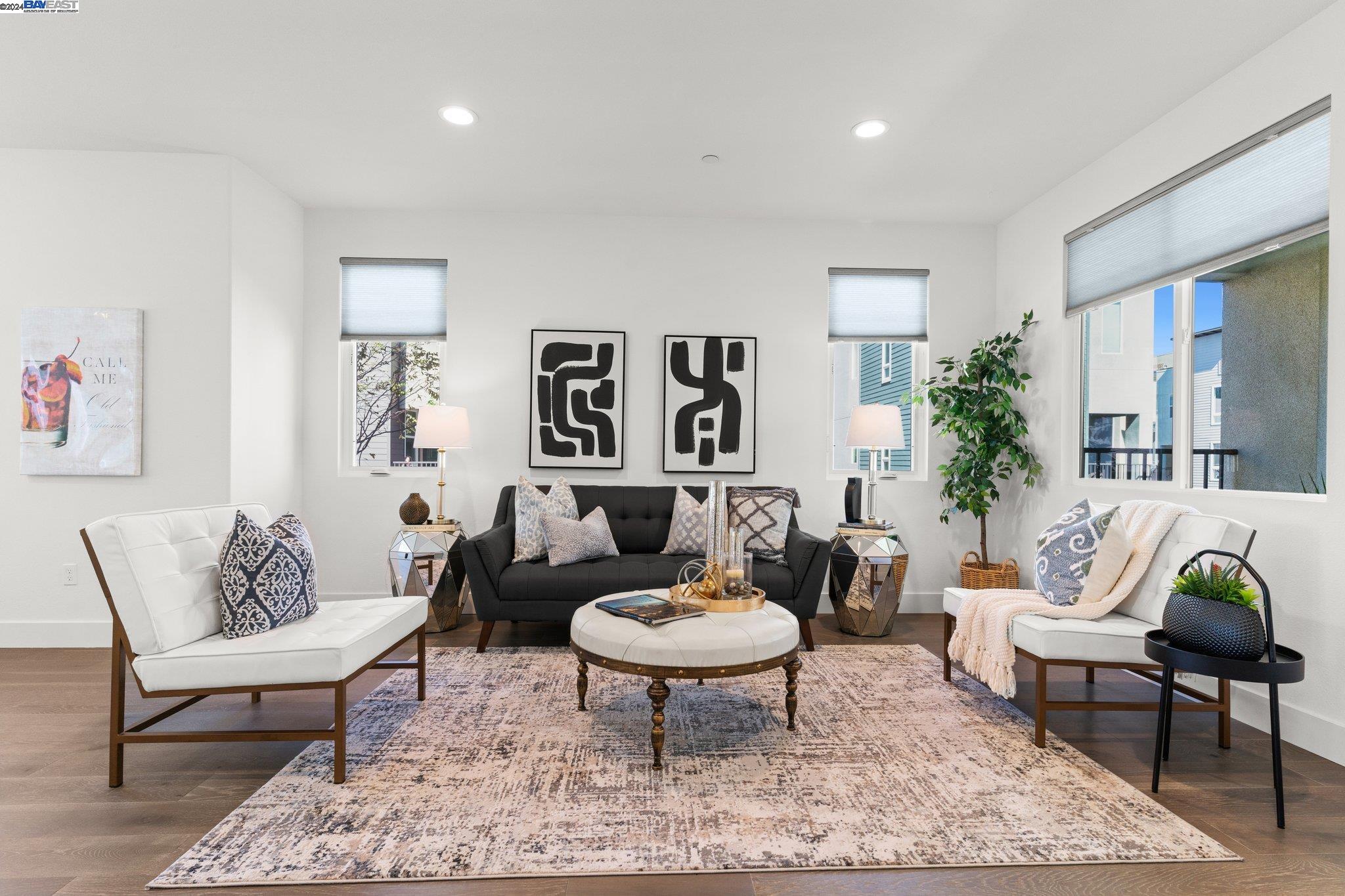 a living room with furniture potted plant and a wooden floor