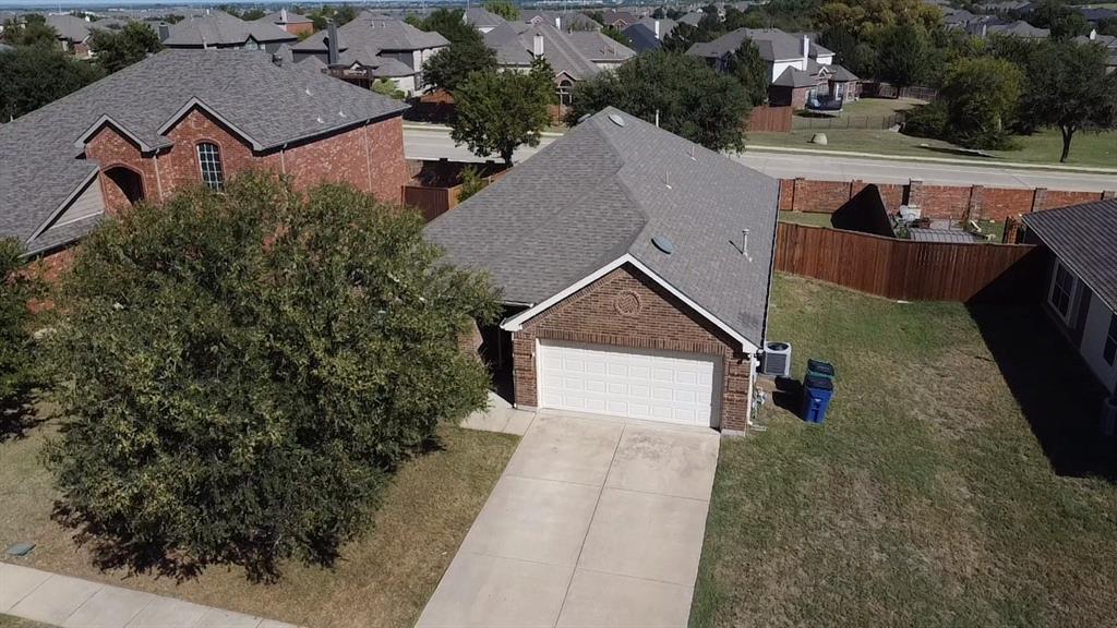 an aerial view of a house with yard