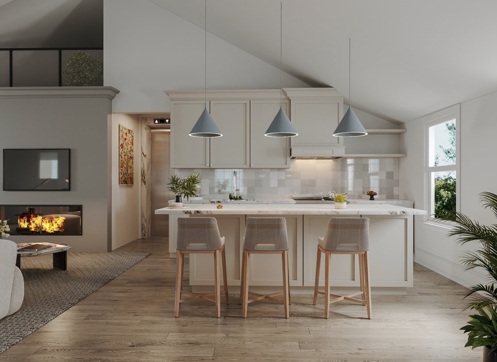 a kitchen with a sink and chairs