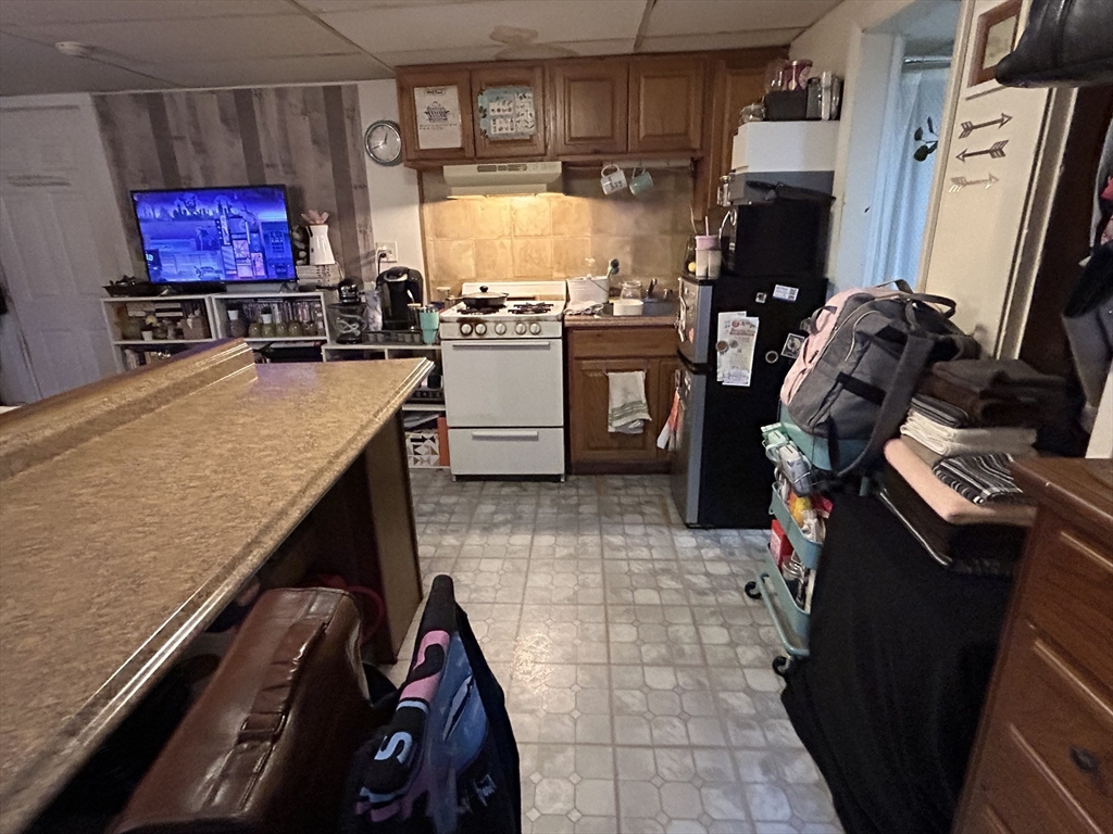 a room with furniture a flat screen tv and a fireplace