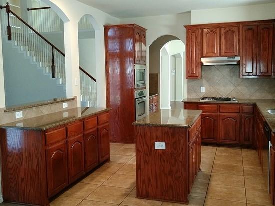 a kitchen with stainless steel appliances granite countertop a sink and cabinets