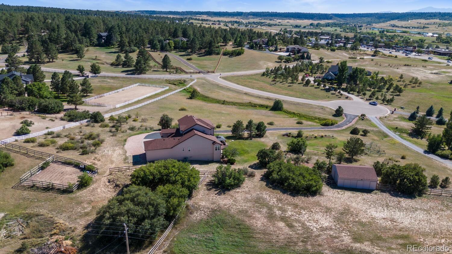 an aerial view of a house with a yard and lake view