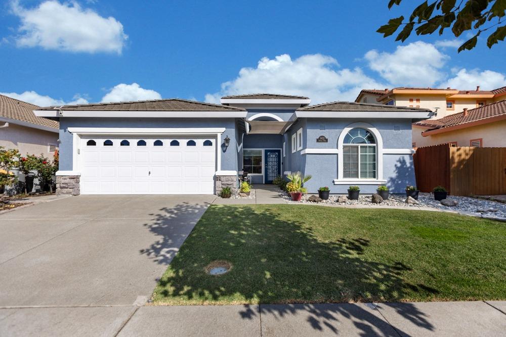 a front view of house with yard and outdoor seating