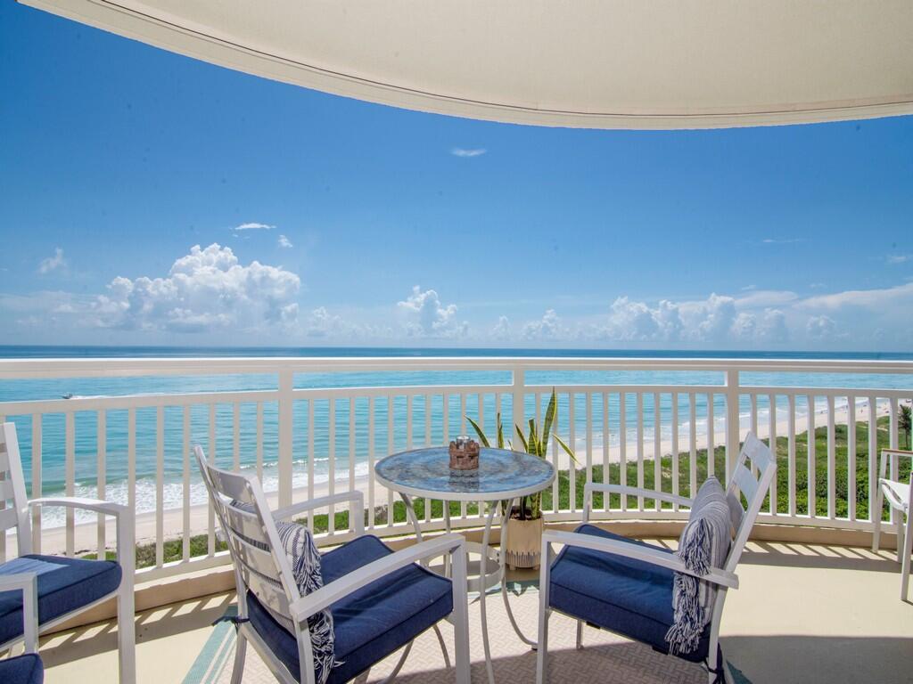 a view of a balcony with furniture