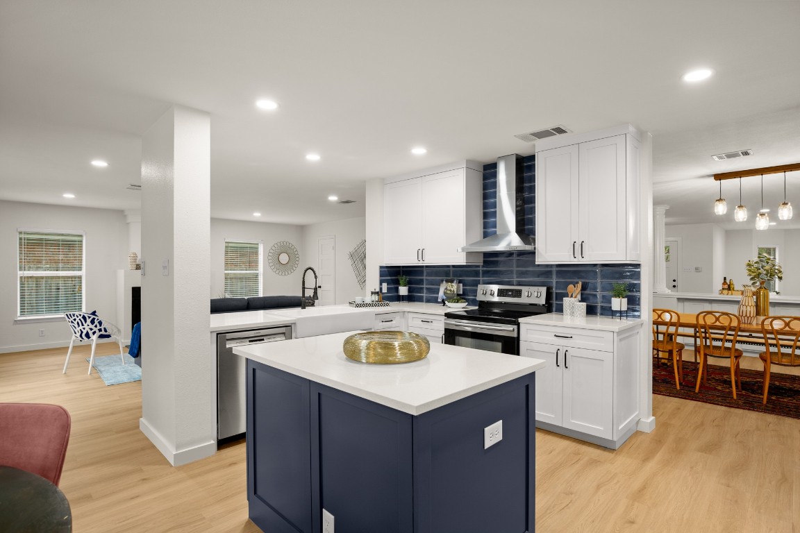 a kitchen with a stove a refrigerator and a stove top oven