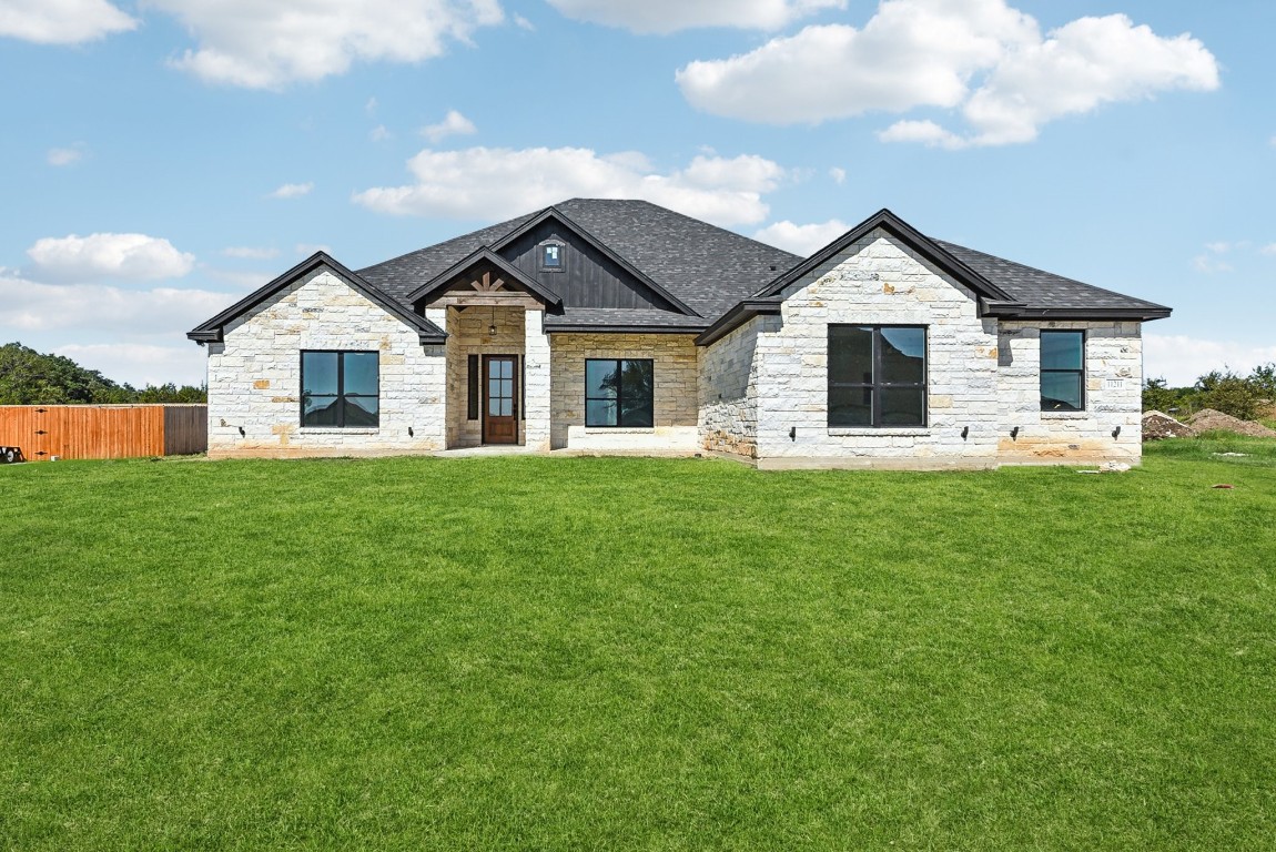 a front view of house with yard and green space