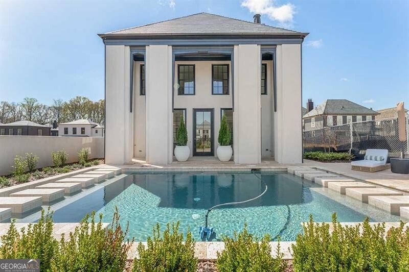 a view of a house with backyard and sitting area