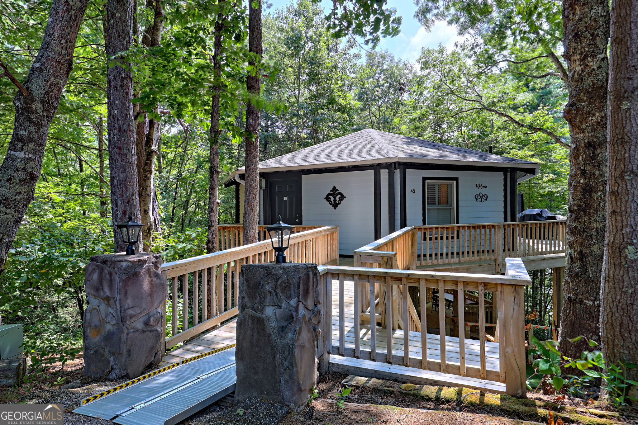 a view of a wooden deck and a backyard