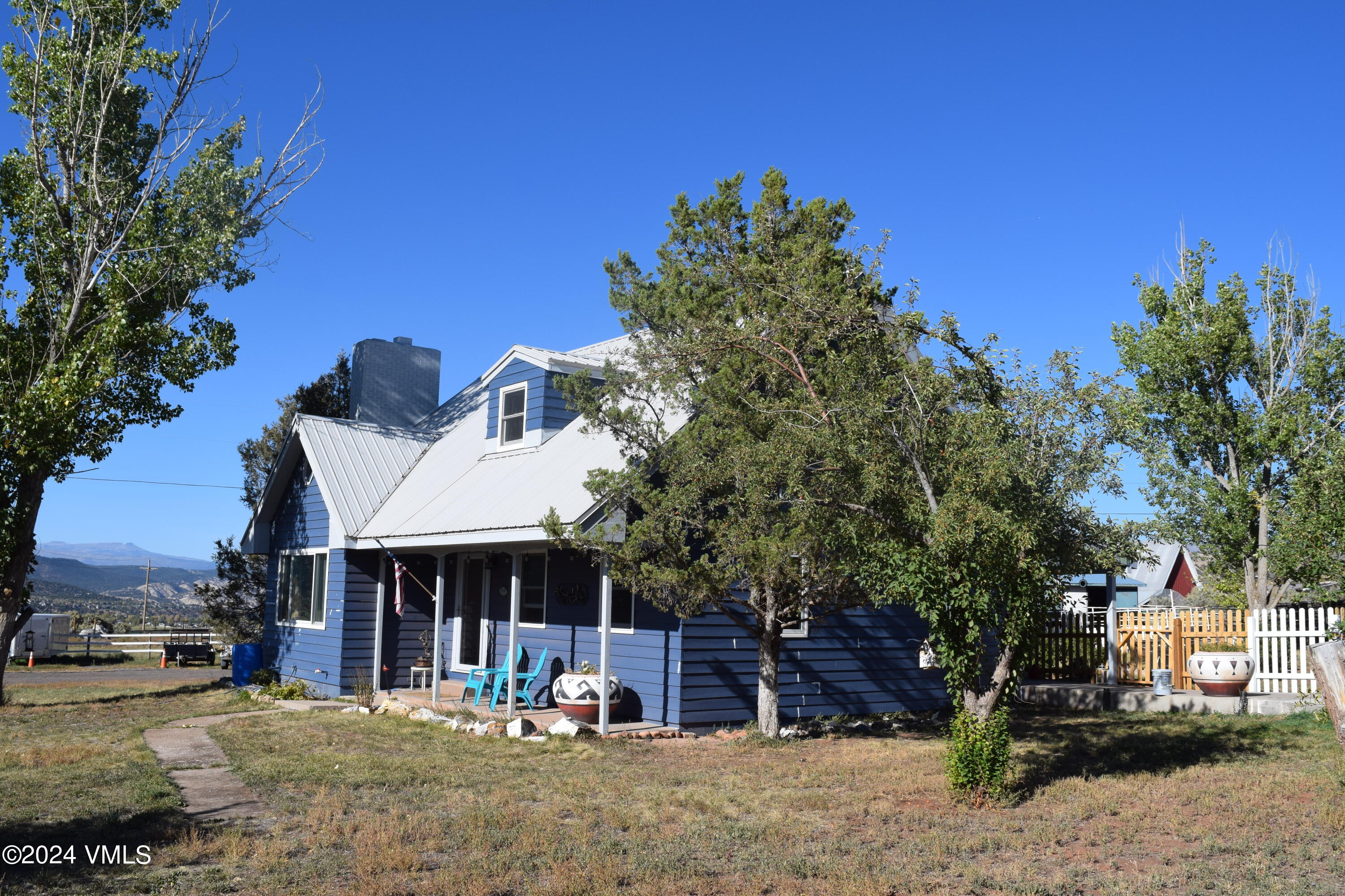 a view of a house with a yard and sitting area