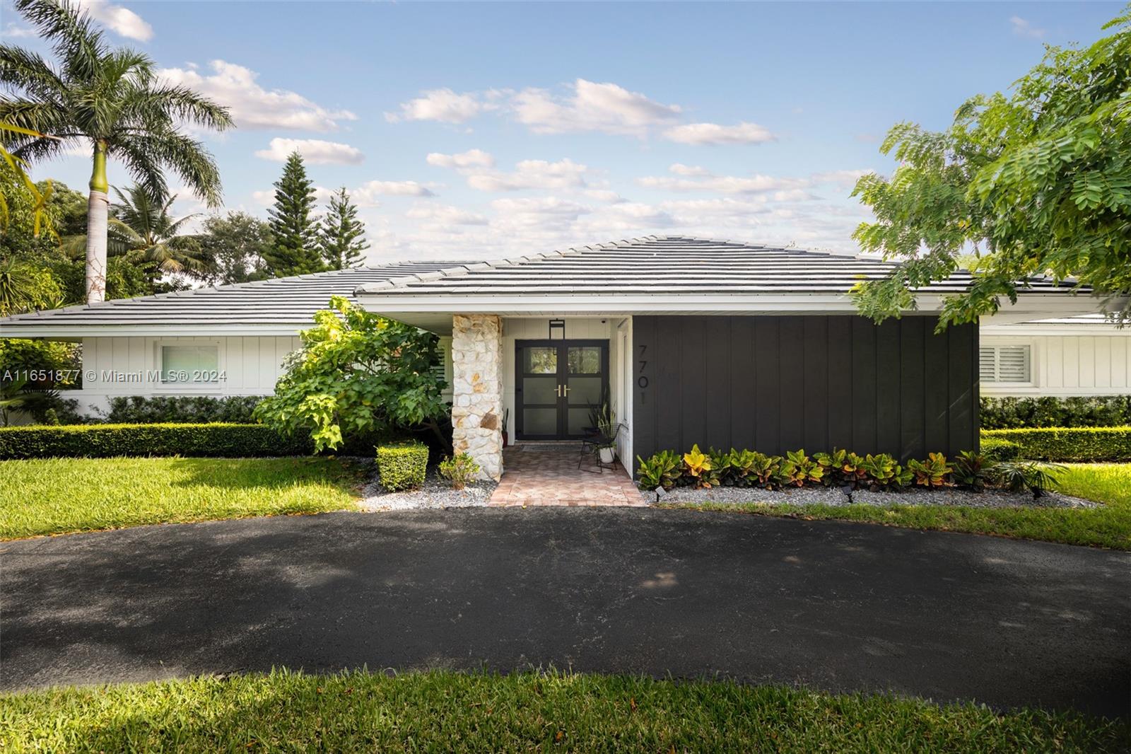 a front view of a house with a yard and a garage